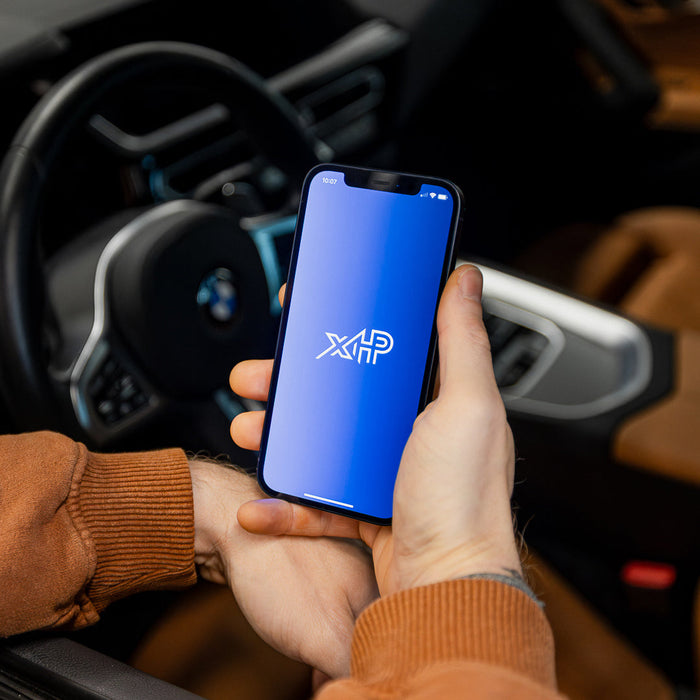 xHP Flashtool app displayed on smartphone in BMW